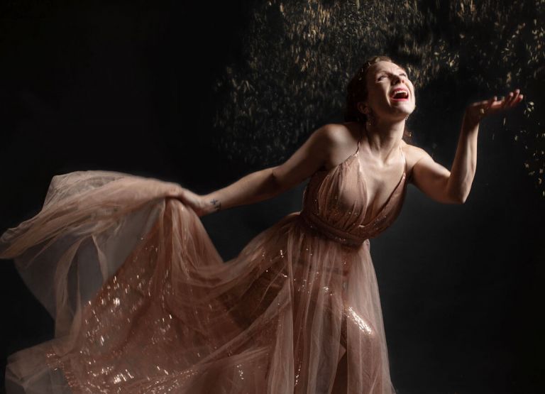 women throwing spring blooms in sequin dress