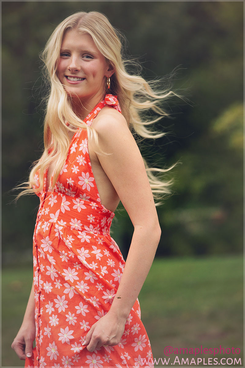 photograph of senior girl in the park with her hair blowing