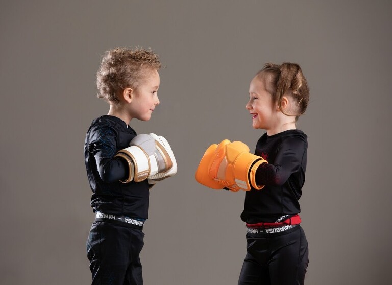 photograph of a brother and sister wearing boxing gloves