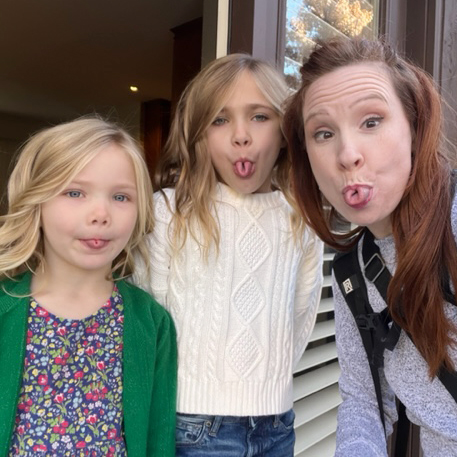 Adrienne Maples and two little girls showing their rolled tongue to the camera.