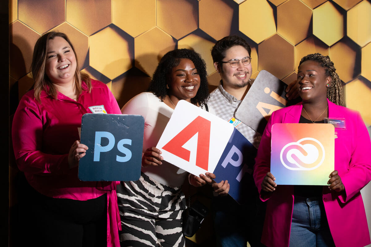 college kids posing in a photo booth at an Adobe event