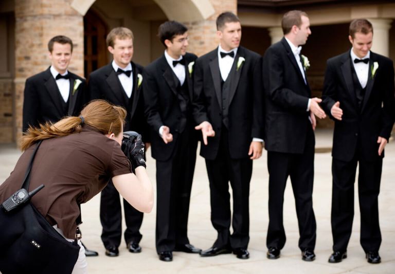 wedding photographer photographing groomsmes